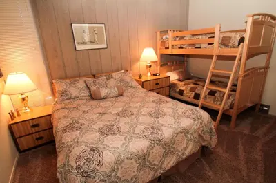 a bedroom with a bed and a bunk bed at Mammoth Ski & Racquet Club #84 in Mammoth Lakes