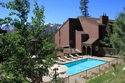 a swimming pool in front of a house at Mammoth Ski & Racquet Club #84 in Mammoth Lakes