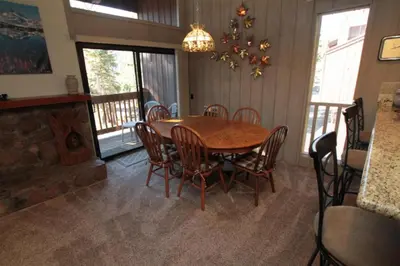 a dining room with a wooden table and chairs at Mammoth Ski & Racquet Club #84 in Mammoth Lakes