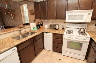 a kitchen with a sink and a stove top oven at Mammoth Ski & Racquet Club #84 in Mammoth Lakes