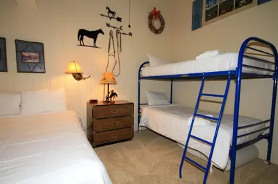 a bedroom with two bunk beds and a ladder at Mammoth Ski Racquet Club 67 in Mammoth Lakes