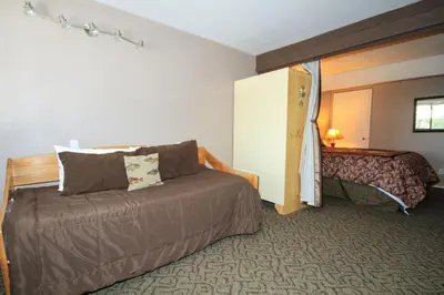 a hotel room with a couch and a bed at Mammoth Ski Racquet Club 94 2 bedroom Dog Friendly in Mammoth Lakes