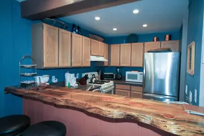 a kitchen with a wooden counter top and a refrigerator at Mammoth Ski Racquet Club 94 2 bedroom Dog Friendly in Mammoth Lakes