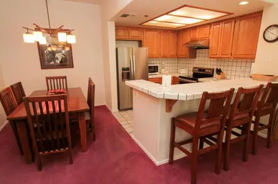 a kitchen and dining room with a table and chairs at Silver Bear #40 in Mammoth Lakes