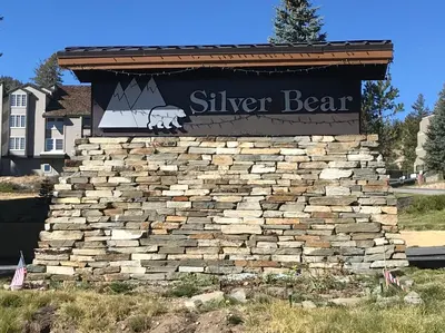 a sign for a silver bear on a stone wall at Silver Bear #40 in Mammoth Lakes