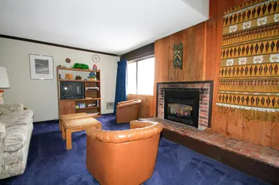 a living room with a fireplace and a couch at Mammoth Ski Racquet Club 129 in Mammoth Lakes
