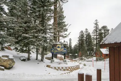 a sign for a ski resort in the snow at Mammoth Ski Racquet Club 120 - Pet Friendly in Mammoth Lakes