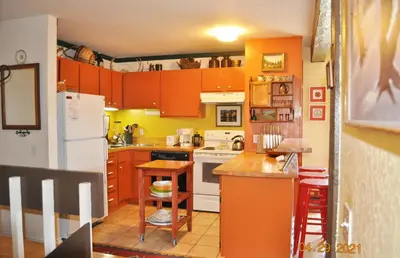 a kitchen with orange cabinets and a white refrigerator at Mammoth Ski Racquet Club 54 in Mammoth Lakes