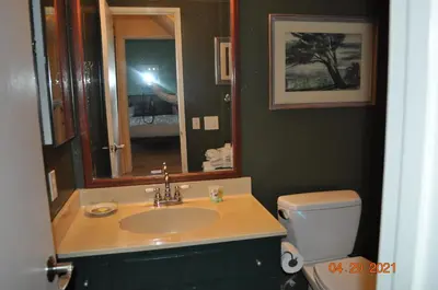 a bathroom with a sink and a mirror and a toilet at Mammoth Ski Racquet Club 54 in Mammoth Lakes