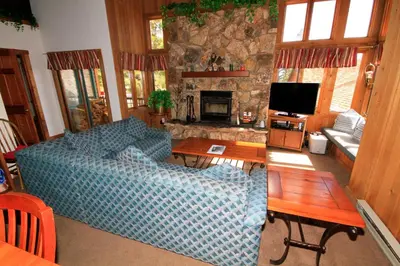 a living room with a blue couch and a fireplace at Mountainback 115 3 bedroom loft in Mammoth Lakes