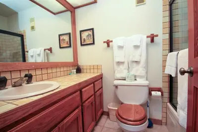 a bathroom with a toilet and a sink and a mirror at Mountainback 115 3 bedroom loft in Mammoth Lakes