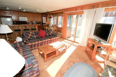 a living room with two couches and a television at Mountainback 112 Corner Unit in Mammoth Lakes
