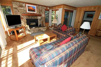 a living room with a couch and a fireplace at Mountainback 112 Corner Unit in Mammoth Lakes