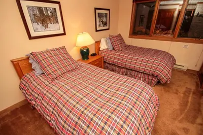 two beds sitting next to each other in a room at Mountainback 111 in Mammoth Lakes