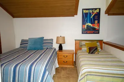 a bedroom with two beds and a lamp and a picture at Mountainback 105 Loft Den in Mammoth Lakes