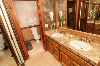 a bathroom with two sinks and a toilet at Mountainback 94 in Mammoth Lakes