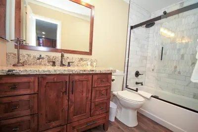 a bathroom with a sink and a toilet and a mirror at Mammoth Ski Racquet Club 12 - Pet Friendly in Mammoth Lakes