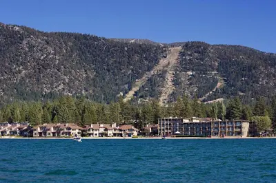 a resort on the shore of a lake with a mountain at Tahoe Lakeshore Lodge & Spa in South Lake Tahoe
