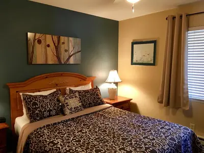 a bedroom with a large bed and a window at Tahoe Lakeshore Lodge & Spa in South Lake Tahoe