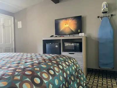 a bedroom with a bed and a flat screen tv at Travel Inn in South Lake Tahoe