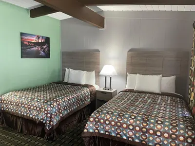 a hotel room with two beds next to each other at Travel Inn in South Lake Tahoe