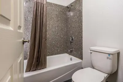 a bathroom with a toilet and a tub and a shower at Motel 6-Westley, CA in Westley