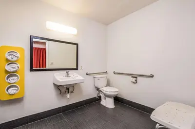 a bathroom with a toilet sink and a mirror at Motel 6-Westley, CA in Westley