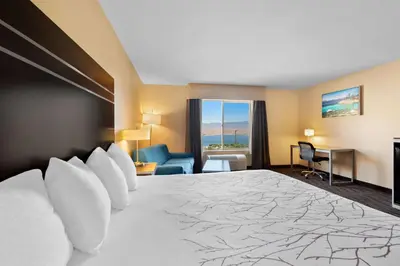 a hotel room with a large bed and a room at Best Western Topaz Lake Inn in Gardnerville
