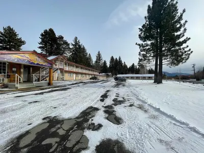 a snow covered street in front of a building at Beverly Lodge in South Lake Tahoe
