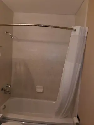 a bathroom with a shower curtain and a toilet at Beverly Lodge in South Lake Tahoe