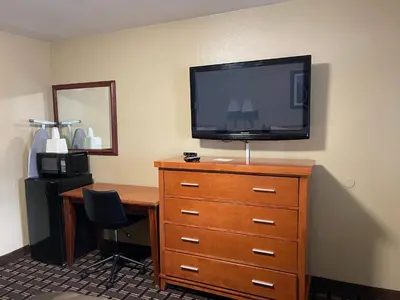 a room with a desk and a television on a dresser at Tahoe Hacienda Inn in South Lake Tahoe