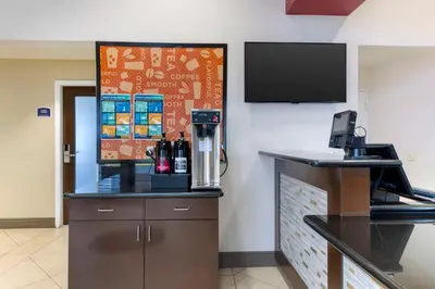 a coffee shop with a counter and a tv on the wall at Best Western Fallon Inn & Suites in Fallon