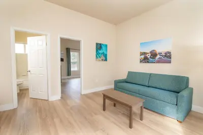 a living room with a blue couch and a table at Westhaven Inn Pollock Pines Camino in Pollock Pines
