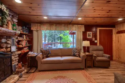 a living room with a couch and a chair at 16 Chipmunks Holiday in Wawona
