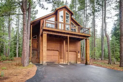 a tree house in the woods with a balcony at Wooded Escape in Donner Pines Tract
