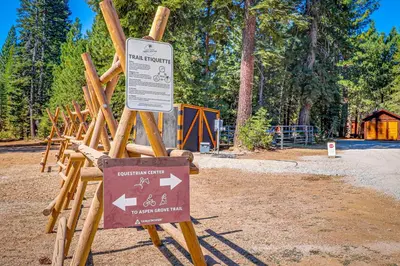 a sign in front of a park with a wooden fence at Wooded Escape in Donner Pines Tract