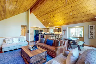 a living room with a couch and a table at Wooded Escape in Donner Pines Tract