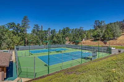 a tennis court with two tennis courts at Pine Mountain Magic in Groveland