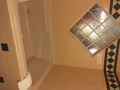 a bathroom with a shower and a window at Miners Inn in Mariposa