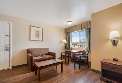 a living room with a couch and a table at SureStay Hotel by Best Western Fernley in Fernley