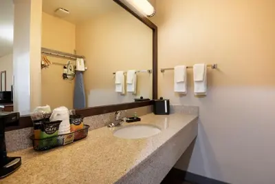 a bathroom with a sink and a mirror at SureStay Hotel by Best Western Fernley in Fernley