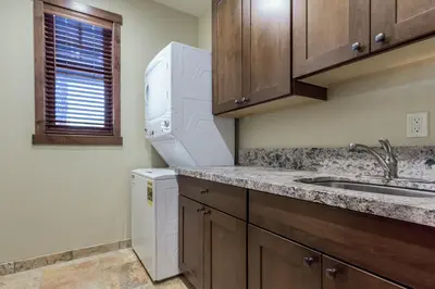 a kitchen with a sink and a washer and dryer at Gray Bear 454 in Mammoth Lakes