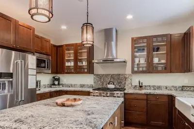 a kitchen with wooden cabinets and a granite counter top at Gray Bear 454 in Mammoth Lakes