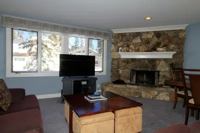 a living room with a tv and a fireplace at Mountainback 62 in Mammoth Lakes