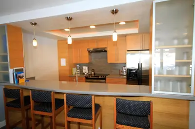 a kitchen with a large counter with chairs around it at Mountainback 62 in Mammoth Lakes