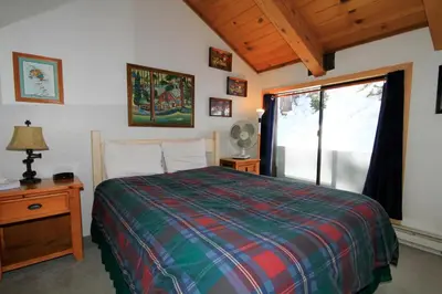 a bedroom with a bed and a large window at Courchevel 51 in Mammoth Lakes
