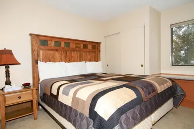 a bedroom with a large bed and a window at Crestview 63 in Mammoth Lakes