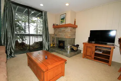a living room with a television and a fireplace at Crestview 63 in Mammoth Lakes