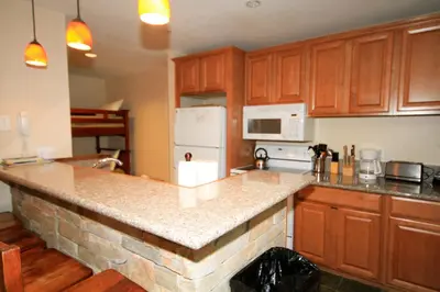 a kitchen with wooden cabinets and a counter top at Crestview 63 in Mammoth Lakes