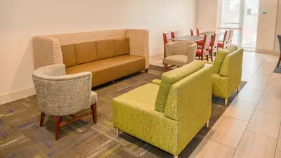 a waiting room with chairs and a couch and a table at Holiday Inn Express Porterville by IHG in Porterville